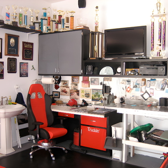 Organized garage workspace with cabinets and racing chair - Ira from Upland, CA