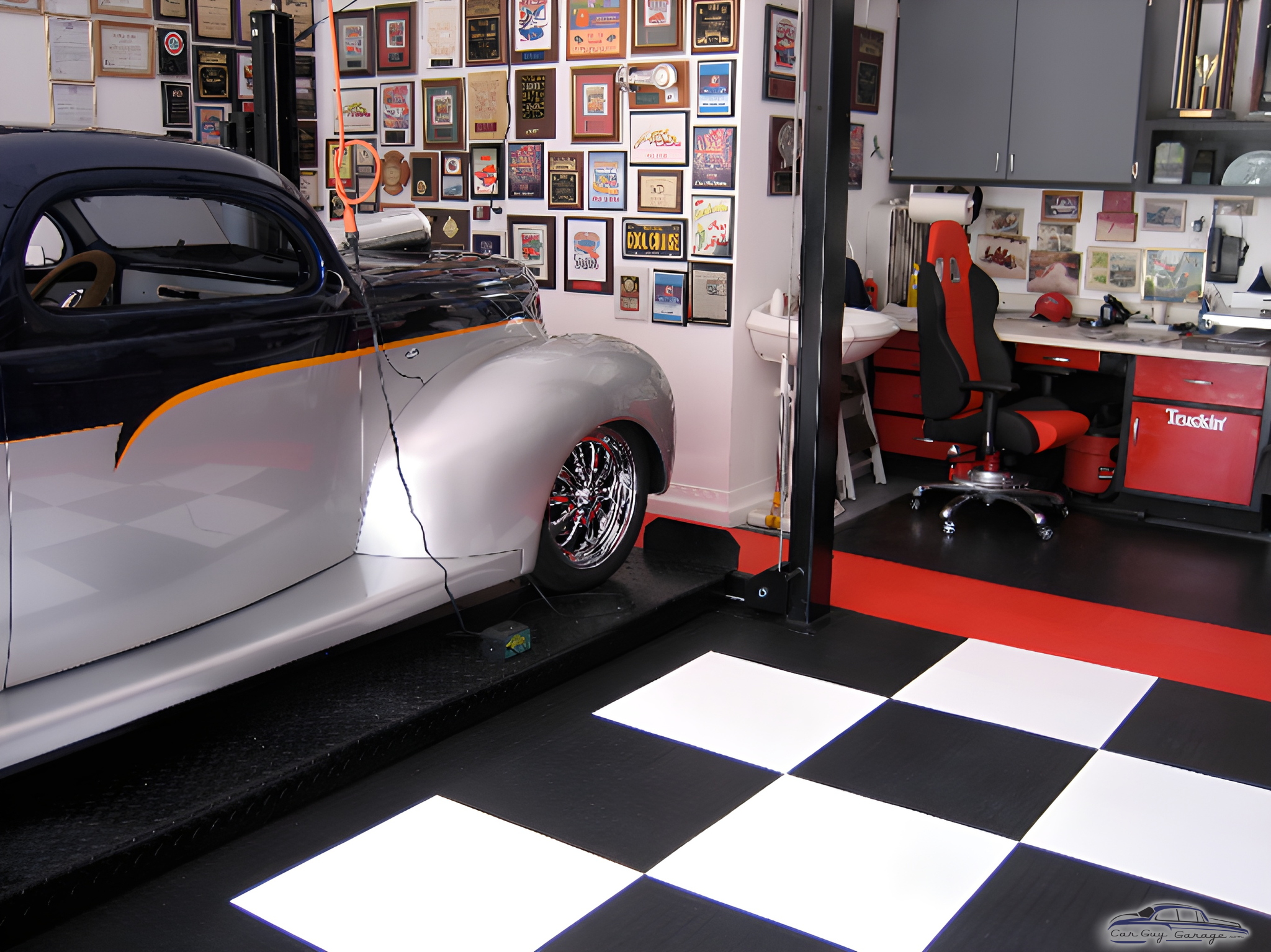 Custom garage with car lift, checkered floor, and wall art - Ira from Upland, CA