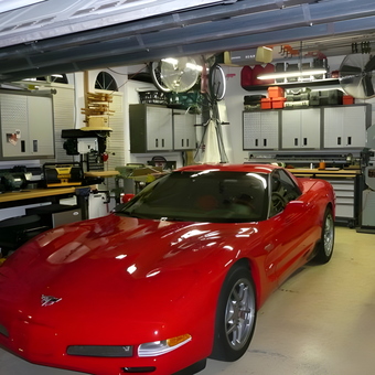Organized garage with red sports car and storage cabinets - John from Plantation, FL