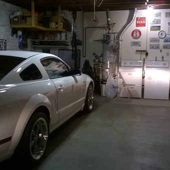 Organized garage with Mustang, tool storage, and wall decor - Tony from Salinas, Ca.