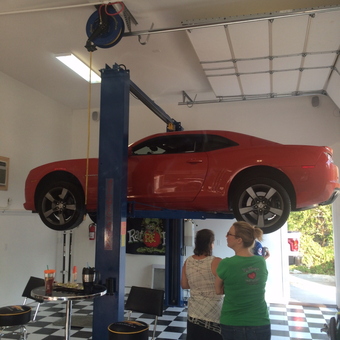 Home garage with car lift, bar stools, and checkered floor - Brad from Highland Village, Tx