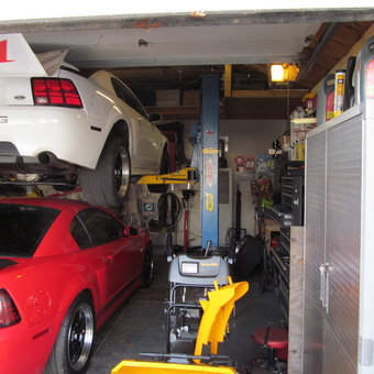 Organized garage with car lift, cabinets, and tool storage - Howie from East Yaphank, NY