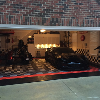 Custom garage with black car, motorcycles, and checkered floor - Rocket