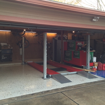 Organized garage with car lift and cabinets - DingLifters from Cypress, Texas
