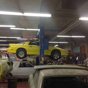 Yellow Camaro on Car Lift in Busy Garage - Big Daddy Fetch from Branchburg, New Jersey