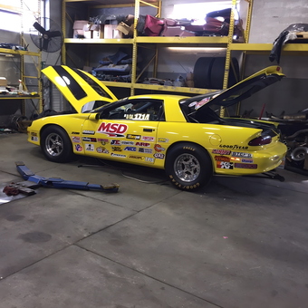 Yellow race car in organized garage with tools and parts - Big Daddy Fetch from Branchburg, new jersey
