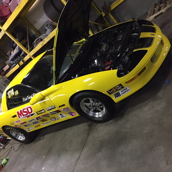 Yellow race car with decals in organized garage - Big Daddy Fetch from Branchburg, New Jersey