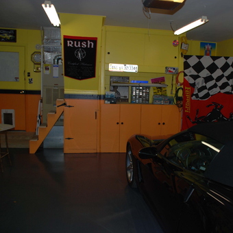 Organized garage with cabinets, car, and Ferrari flag - Daniel Vielhaber from Indianapolis, In