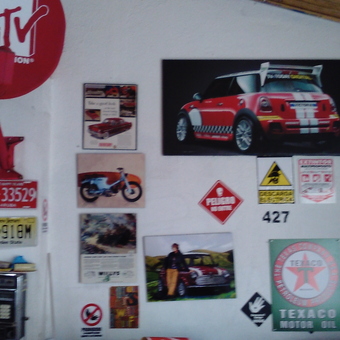 Garage wall with vintage signs, posters, and license plates - ricardo from Pasto, Narino Colombia
