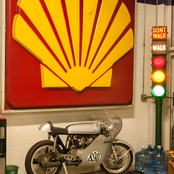 Shell Sign, Traffic Light, Vintage Motorcycle in Garage - MotoeXotica from St. Louis, MO