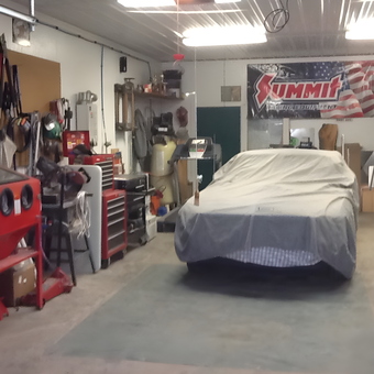 Organized garage with tool chests, sandblaster, and covered car - Gary from Munising, Michigan