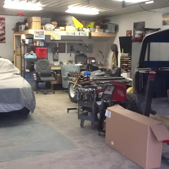 Organized garage with workbench, tool cart, and covered car - Gary from Munising, Michigan