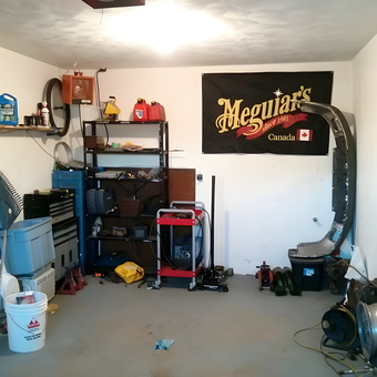 Organized garage with shelving, tools, and Meguiar's banner - Nick from Dieppe, NB