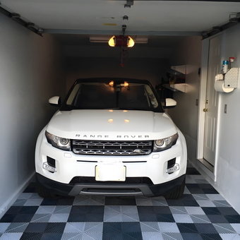 Modern garage with checkered floor tiles and storage - Hank's Garage from Dumont, New Jersey