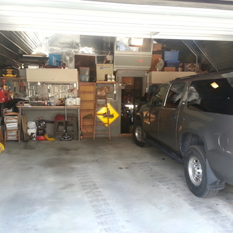 Organized garage with workbench, tools, and SUV - Jimbobillybob from Delhi, Iowa