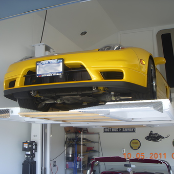Yellow sports car on four post lift in garage - Steve from Smithtown, NY