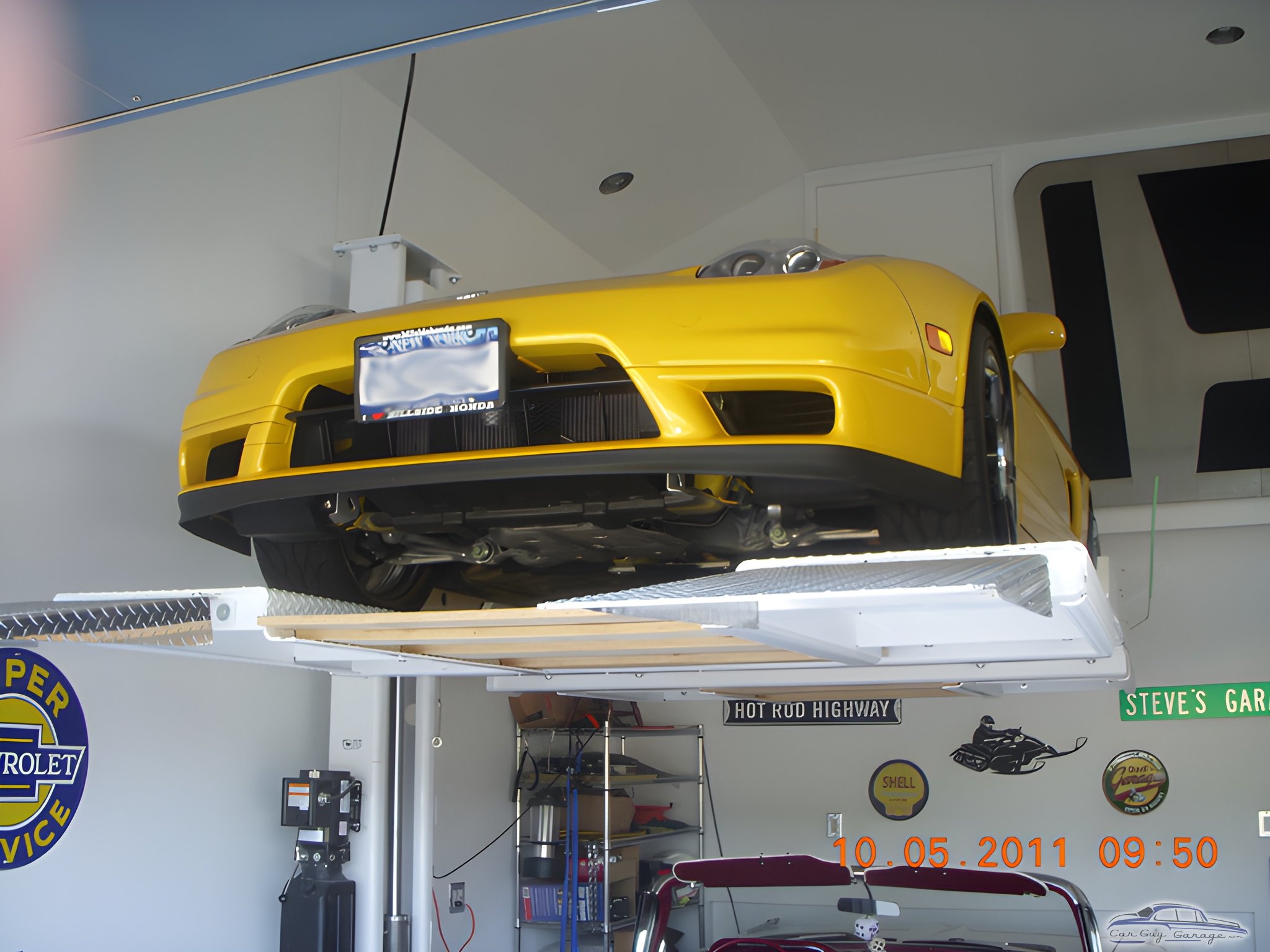 Yellow sports car on four post lift in garage - Steve from Smithtown, NY