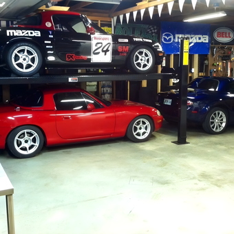 Garage Car Lift with Mazda Miatas and Wall Banners - Rick Worth from Elmwood, Tennessee