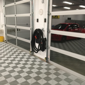Clean garage with tile flooring and wall-mounted vacuum - Larry from Plymouth, Mi