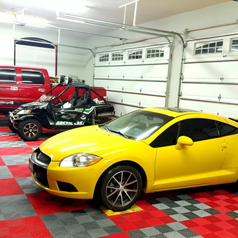 Organized garage with red truck, yellow car, custom flooring - Dave from Dubois, Idaho