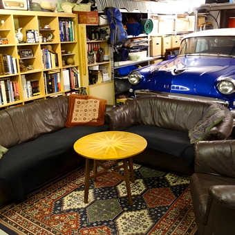 Classic car garage lounge with leather sofas and bookshelves - Orn from Reykjavik, Iceland