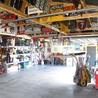 Organized garage with vintage signs and tools - Andy McDougall from Christchurch