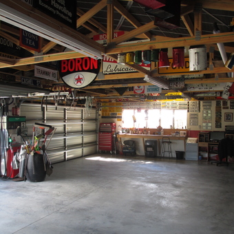 Organized garage with vintage signs and tool storage - Andy McDougall from Christchurch
