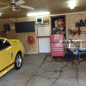 Organized garage with red tool chest and yellow car - copper red from Moncton, New Brunswick