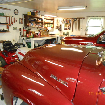 Organized garage with red Ford trucks and tools - Hairs from Lehighton, PA