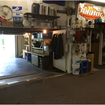 Organized garage with workbench, wall decor, and storage - Tbird Al from orange, Ct.