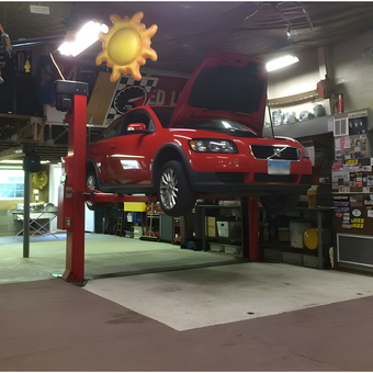 Garage car lift with red Volvo and workspace - Tbird Al from Orange, Ct.