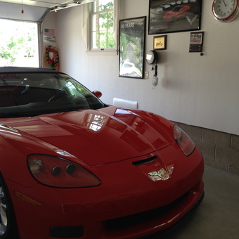 Red Corvette in Clean Garage with Wall Decor - Art from Canton, OH