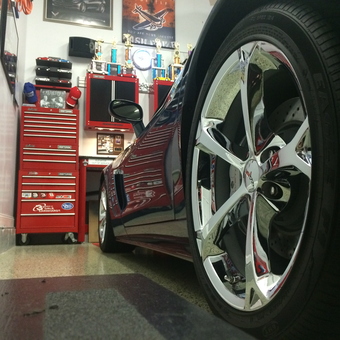 Organized garage with Corvette, red tool cabinets, and wall art - Grand Sport from Revere, MA