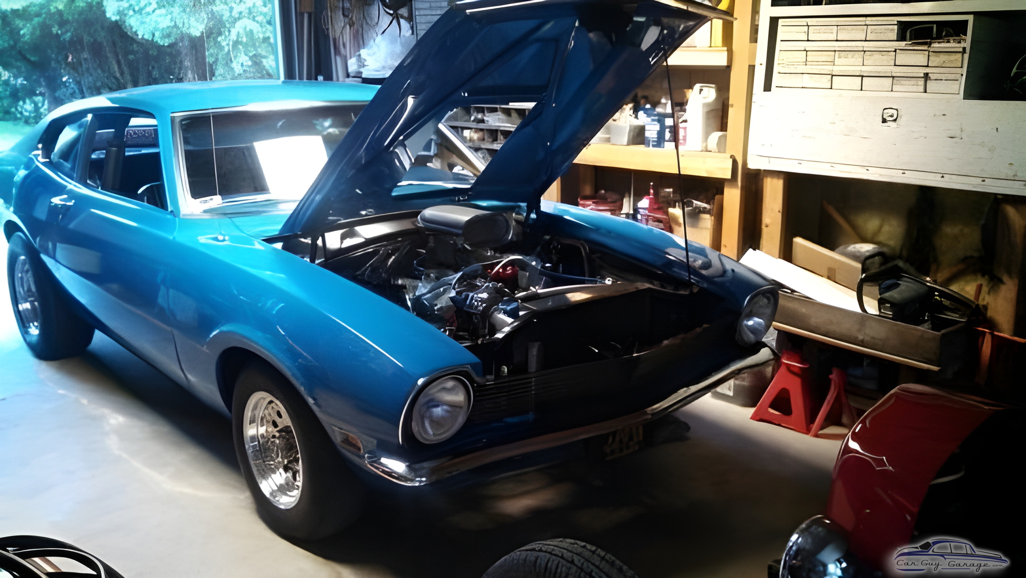 Classic blue muscle car with open hood in garage - Jim from Sharon, Wi