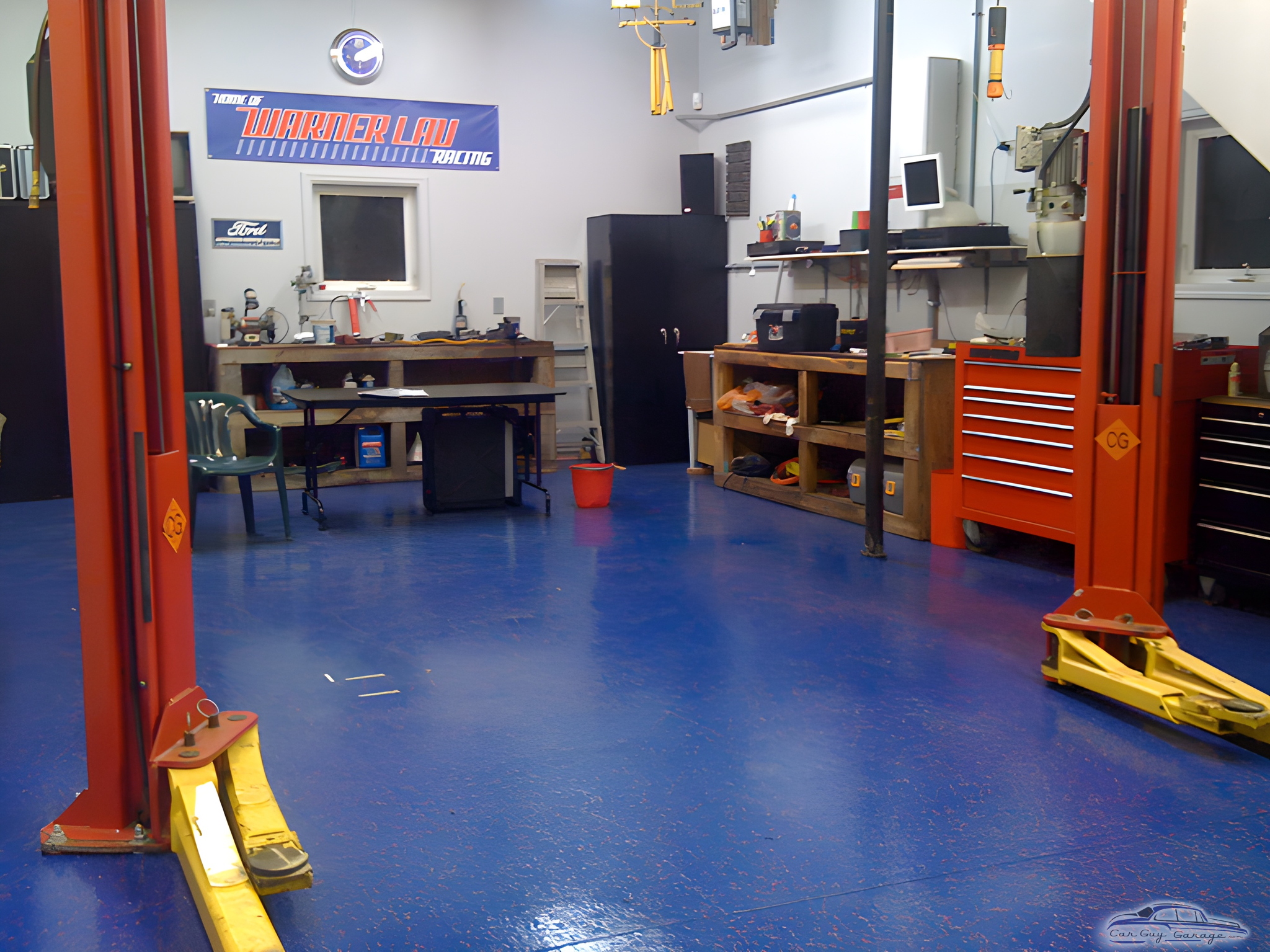 Organized garage with car lift, tool cabinets, and workbenches - David from Plymouth, MI