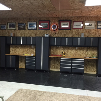 Modern garage with black cabinets and workbenches - Grandpa James 007 from Watkins, CO