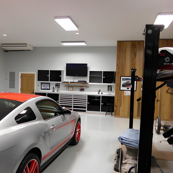 Modern garage with car lift, cabinets, and Mustang - Louis from Bourg, LA