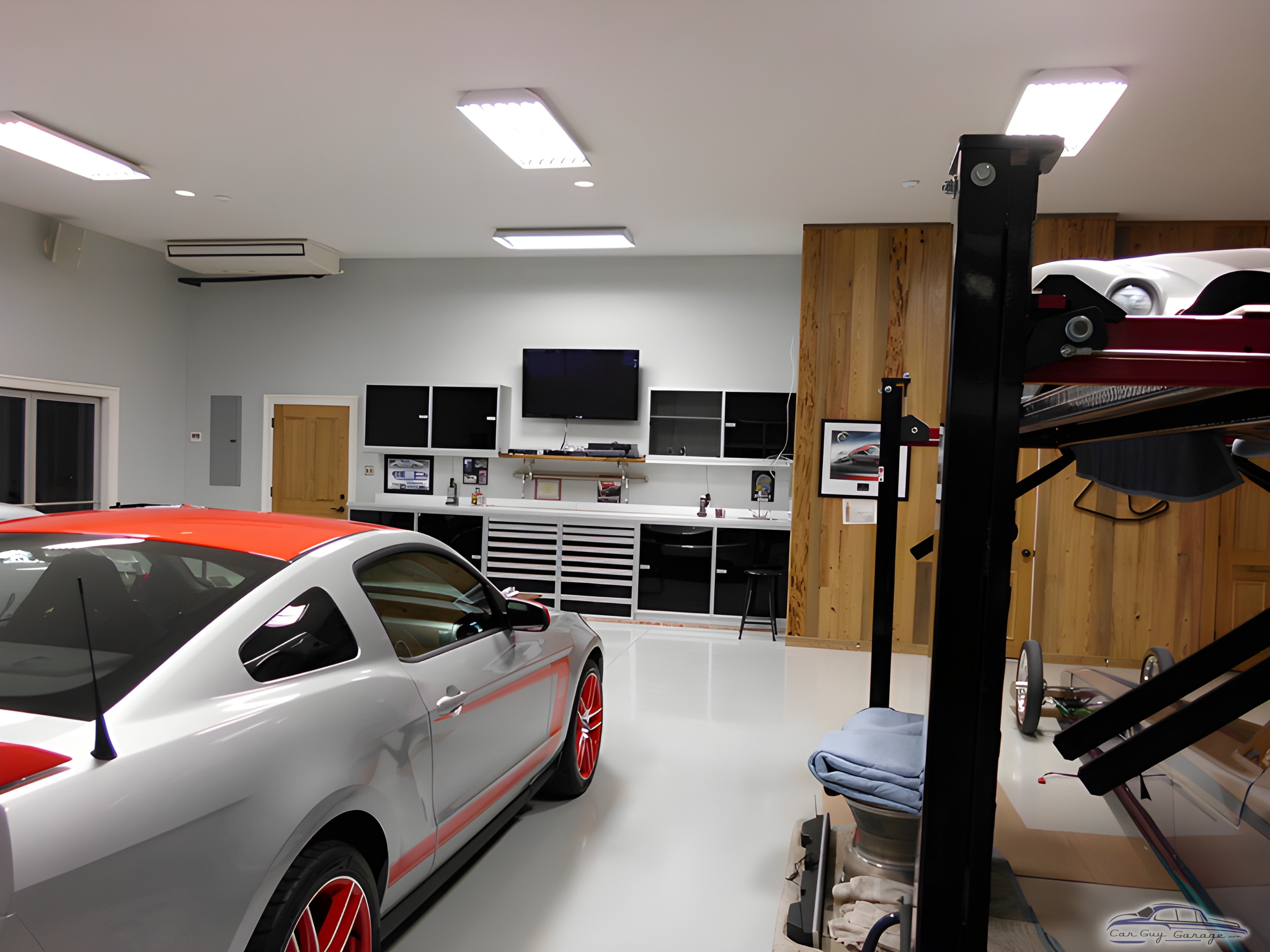 Modern garage with car lift, cabinets, and Mustang - Louis from Bourg, LA