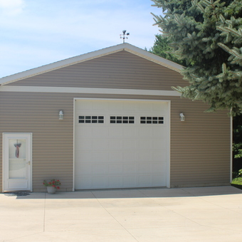 Spacious Tan Garage with White Door and Lighting - Stig from Epworth, IA