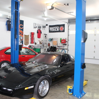 Organized garage with car lift, wall storage, and tools - Stig from Epworth, IA