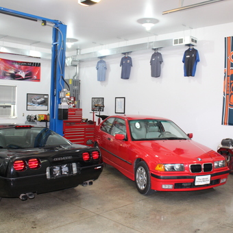 Organized garage with car lift, tool chests, and decor - Stig from Epworth, IA