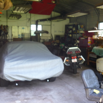 Organized garage with car cover, motorcycle, and tools - Steve from La Crosse, WI