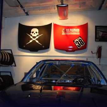 Race Car Garage With Decorated Hoods and Tire Rack - Double Nickel Nine Motorsports from Del Rey, CA