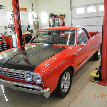 Classic Red Car on Two Post Lift in Clean Garage - Warp2