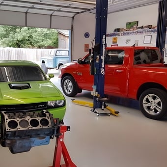 Organized garage with car lift, engine stand, and tools - Donalda from Ulysses, KS