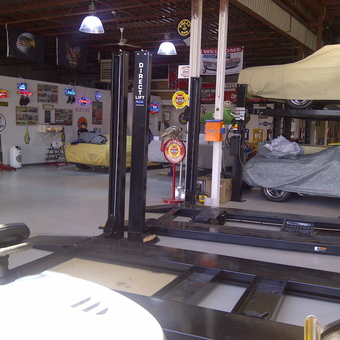 Organized garage with car lifts, neon signs, and wall decor - roid from Kitchener, Ontario