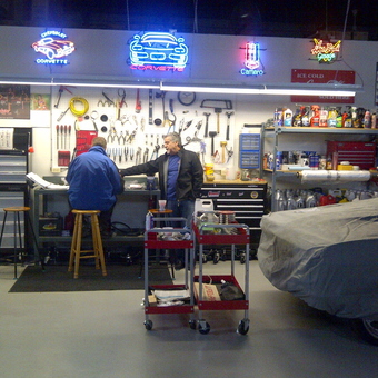 Organized garage workspace with tool chests and neon signs - roid from Kitchener, Ontario