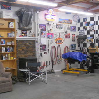 Organized garage with wall decor, tools, and shelves - Plymouth Dennie from kennewick, wa