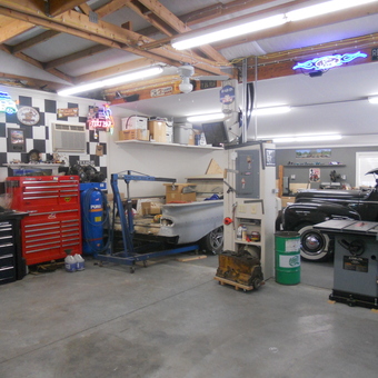 Organized garage with tool chests, neon signs, and classic cars - Plymouth Dennie from Kennewick, WA