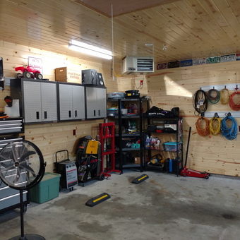 Organized Garage With Cabinets, Tool Chest, and Hose Reels - The Brat Guy from Huxley, IA